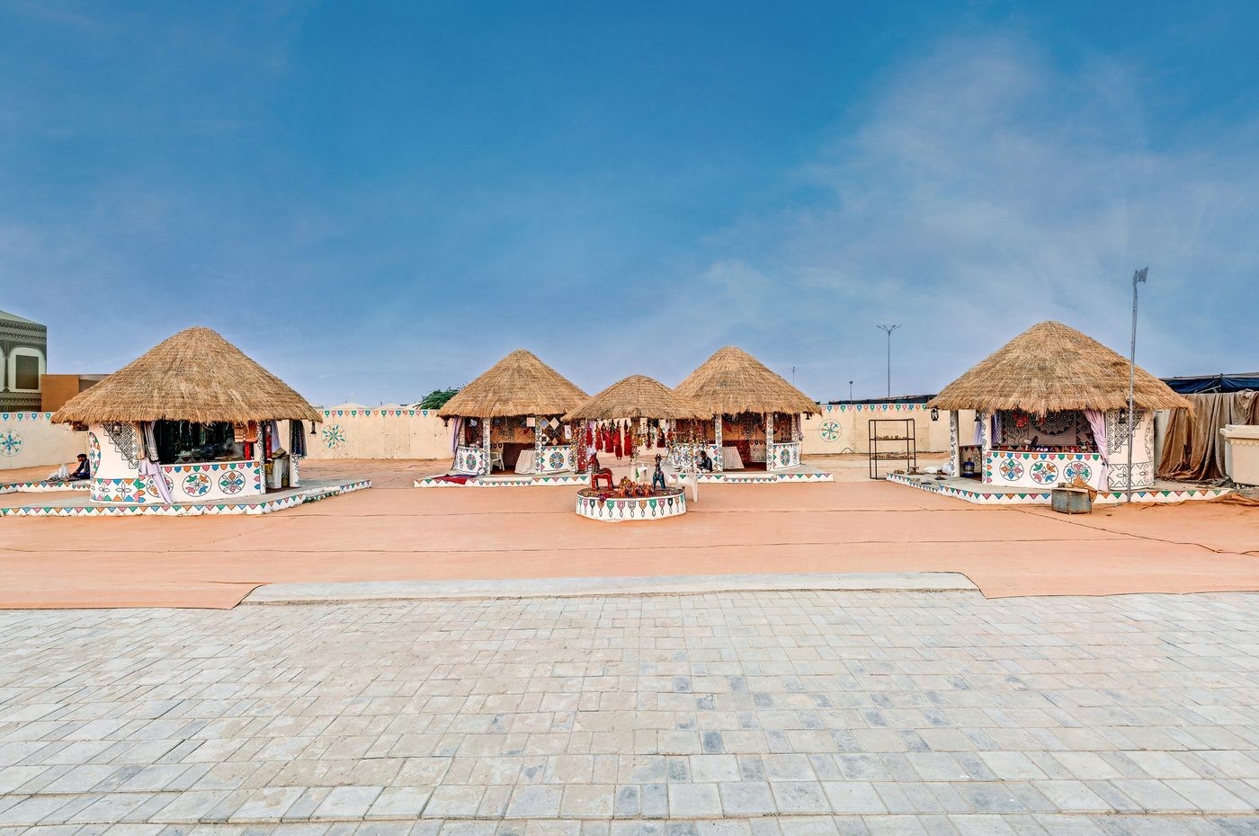 Thatched-roof handicraft huts painted with traditional Kutchi designs at Rann Utsav