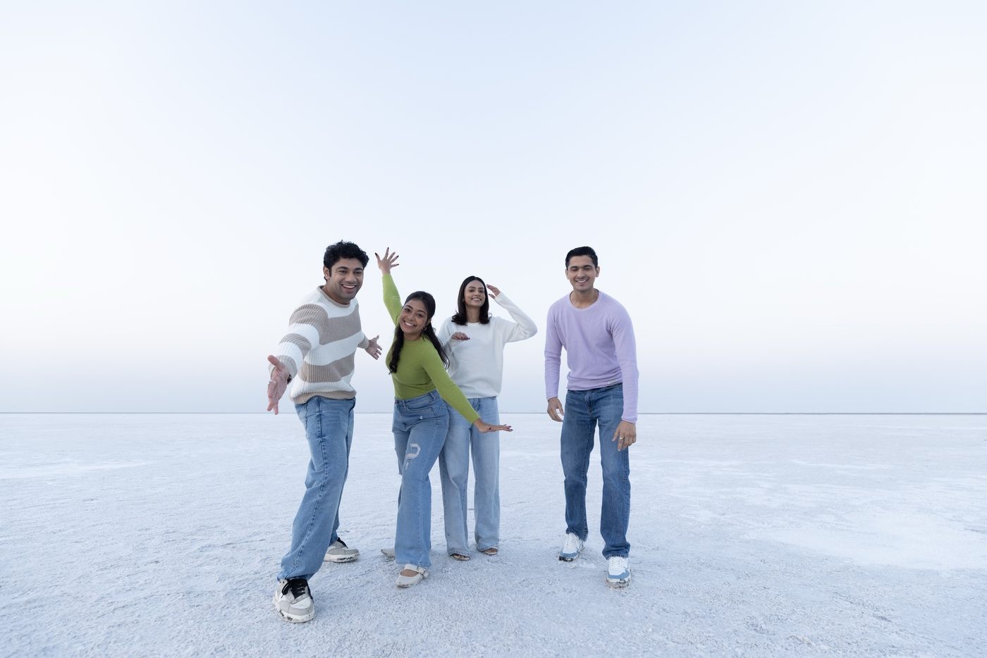 Group of four friends posing on the white salt flats of the Rann of Kutch